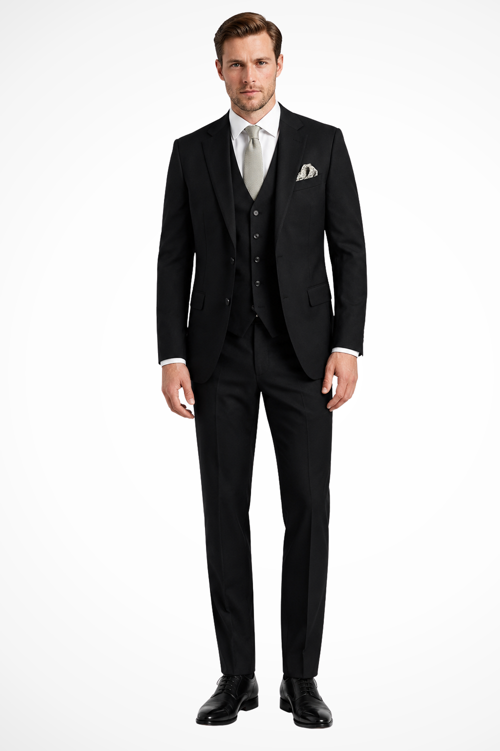 Herre iført tredelt jakkesæt med jakke, vest og lange bukser