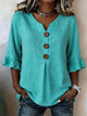 Damebluse med knapper, rund hals og flæseærmer