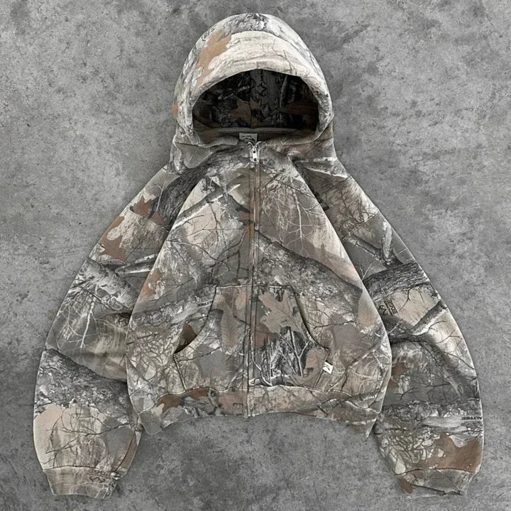 Kort damehættebluse med camouflagemønster og brystlomme