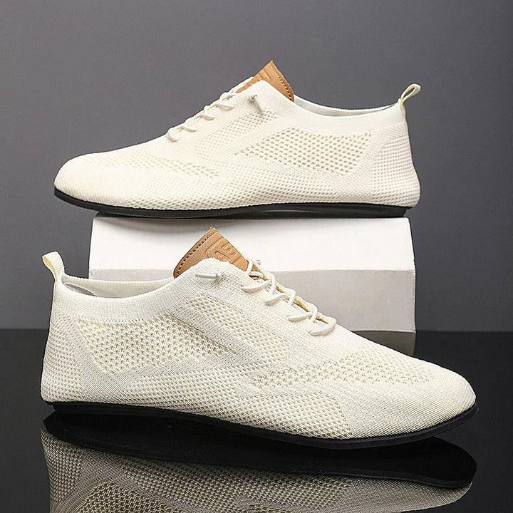 Striksneakers med snørebånd, rund tå og flad sort sål