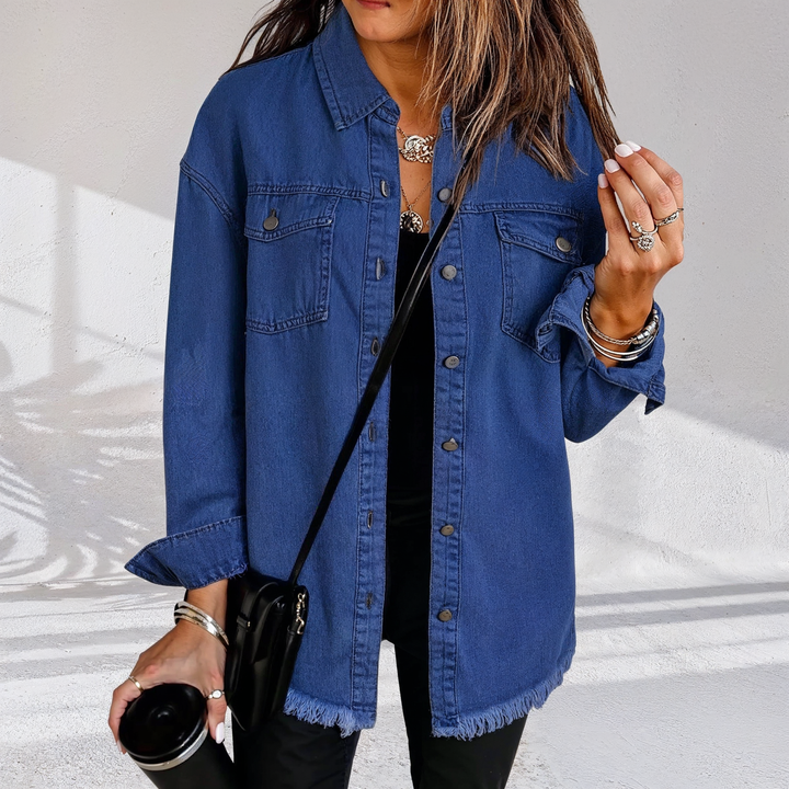 Dame i oversized denimjakke med brystlommer og frynset kant